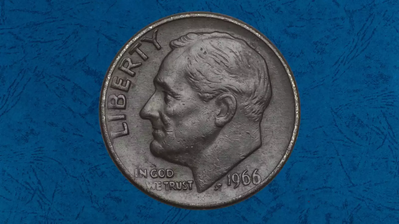 1966 Roosevelt dime missing clad layer error showing copper-colored exposed core on coin surface